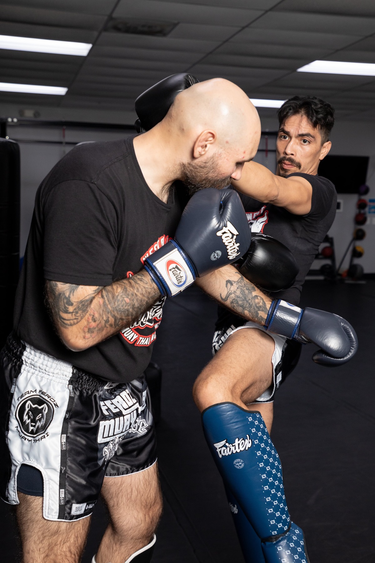 Two adults demonstrating Muay Thai striking technique at Gracie Barra Westchase in Houston