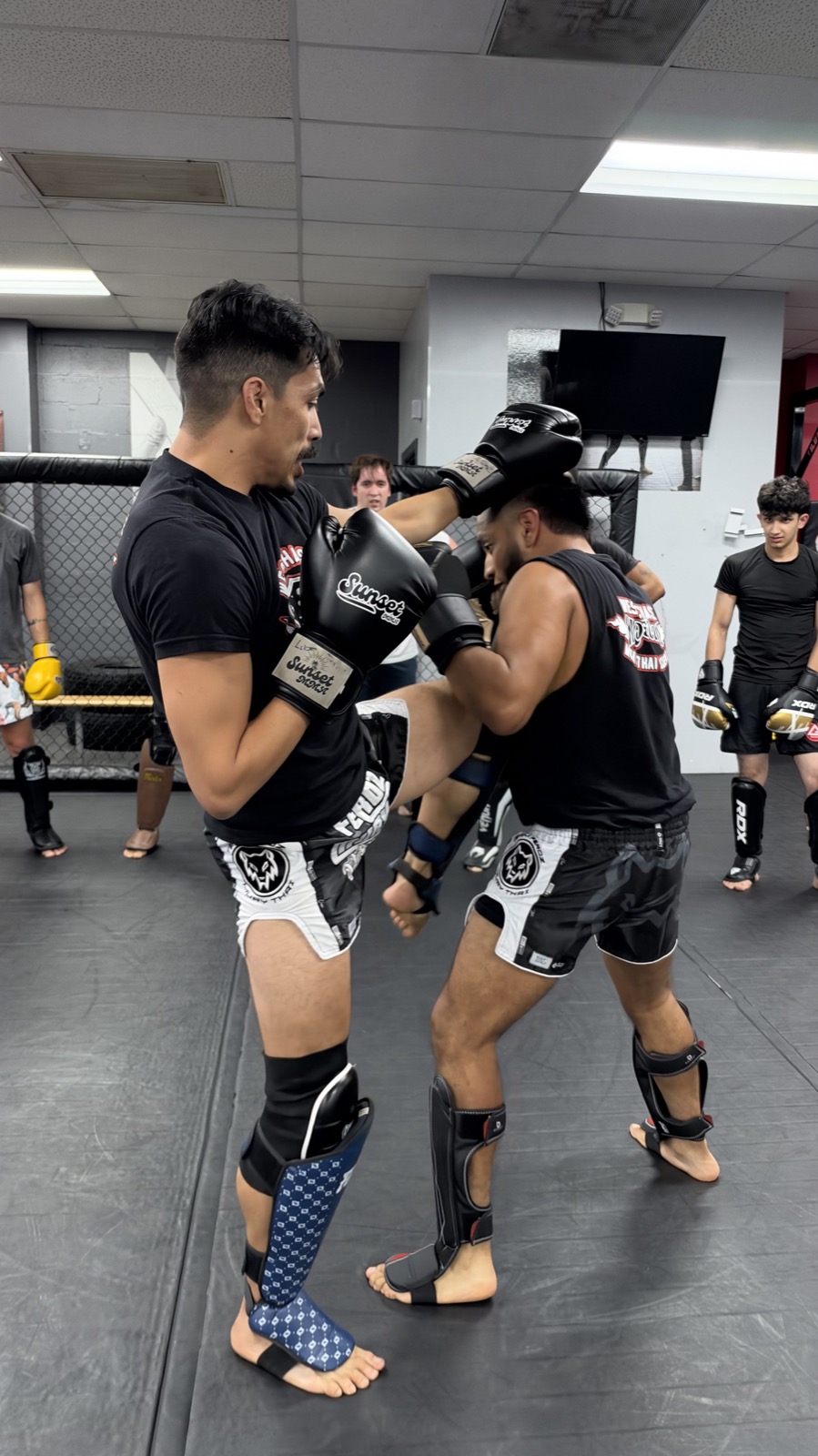 Muay Thai knee technique demonstrated during an adult class at Gracie Barra Westchase in Houston